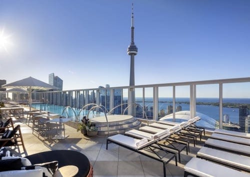 The rooftop of the Bisha hotel with a pool and the CN tower in the back